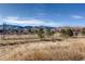 A sprawling equestrian center with riding area, fencing and mountain views providing a wonderful facility for horses at 10425 Red Mountain West, Littleton, CO 80127