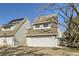 Charming two-story townhome with a single-car garage and grey siding at 10425 Red Mountain West, Littleton, CO 80127