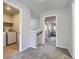 Upstairs hallway with carpet and gray walls, leading to the laundry and other rooms at 10425 Red Mountain West, Littleton, CO 80127