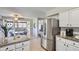 Modern kitchen featuring a stainless steel refrigerator, granite countertops, and an adjacent breakfast nook at 10425 Red Mountain West, Littleton, CO 80127