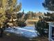 Picturesque pond view framed by mature trees and a snowy landscape in a peaceful outdoor setting at 10425 Red Mountain West, Littleton, CO 80127