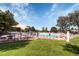 A beautiful community pool with chairs, umbrellas, and a lush green lawn is a great place to relax at 10425 Red Mountain West, Littleton, CO 80127