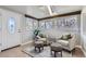 Cozy sunroom featuring a skylight, tiled flooring, and seating area with two chairs and zebra print ottomans at 10425 Red Mountain West, Littleton, CO 80127