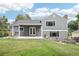Well-maintained backyard with a large patio, manicured lawn, and beautifully landscaped garden beds at 7123 S Hudson Cir, Centennial, CO 80122