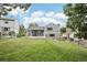 Expansive backyard featuring a lush lawn, mature trees, and an inviting outdoor patio perfect for entertaining at 7123 S Hudson Cir, Centennial, CO 80122
