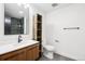Bathroom boasts a modern vanity, sleek fixtures, and stylish, tiled shower at 7123 S Hudson Cir, Centennial, CO 80122
