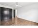 Bright bedroom features wood floors, black sliding closet doors and a modern ceiling fan at 7123 S Hudson Cir, Centennial, CO 80122
