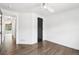 Bright bedroom with wood floors, white walls, black doors, and a modern ceiling fan at 7123 S Hudson Cir, Centennial, CO 80122