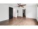 Spacious bedroom featuring wood floors, white walls, black doors, and modern ceiling fan at 7123 S Hudson Cir, Centennial, CO 80122