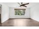 Bright bedroom featuring a modern ceiling fan and a window with a view of lush greenery at 7123 S Hudson Cir, Centennial, CO 80122