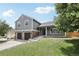 Charming two-story home with a well-manicured lawn and a two-car garage at 7123 S Hudson Cir, Centennial, CO 80122