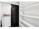 Closet with a modern washer and dryer for your laundry needs and built-in shelving at 7123 S Hudson Cir, Centennial, CO 80122