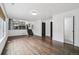 Bright, open-concept living space with hardwood flooring, a staircase, and neutral color palette at 7123 S Hudson Cir, Centennial, CO 80122