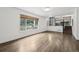 View of the living room and the adjacent kitchen with large windows, hardwood floors and a garden view at 7123 S Hudson Cir, Centennial, CO 80122