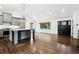 Open-concept living space with hardwood floors, a large window, and seamless flow from kitchen to living area at 7123 S Hudson Cir, Centennial, CO 80122