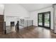 View of the open floorplan showing hardwood floors, staircase and a black framed fireplace at 7123 S Hudson Cir, Centennial, CO 80122