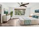 Bright and airy main bedroom with hardwood flooring, large window, and neutral decor at 7123 S Hudson Cir, Centennial, CO 80122