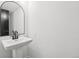 Modern powder room features a sleek pedestal sink and contemporary fixtures at 7123 S Hudson Cir, Centennial, CO 80122