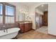 Elegant bathroom with soaking tub, double vanity, and separate shower at 38911 E Wesley Ave, Bennett, CO 80102