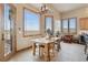 Bright breakfast nook features a farmhouse table and picturesque views at 38911 E Wesley Ave, Bennett, CO 80102