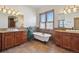 Luxurious bathroom with double vanities and clawfoot tub at 38911 E Wesley Ave, Bennett, CO 80102