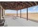 Covered patio with picnic table and views at 38911 E Wesley Ave, Bennett, CO 80102