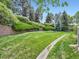Lush backyard with mature trees and a neatly manicured lawn at 6626 S Reed Way # A, Littleton, CO 80123