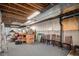 Unfinished basement with exposed ceiling, providing ample storage or renovation potential at 6626 S Reed Way # A, Littleton, CO 80123