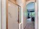 Bathroom with a glass enclosed shower, archway to bedroom, and neutral wall paint at 6626 S Reed Way # A, Littleton, CO 80123