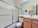 Full bathroom featuring a toilet, shower-bathtub, and vanity at 6626 S Reed Way # A, Littleton, CO 80123