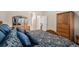 Bedroom featuring a decorative bed with pillows, carpet flooring, and wardrobe at 6626 S Reed Way # A, Littleton, CO 80123