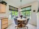 Cozy dining area featuring a round table with four chairs and natural lighting at 6626 S Reed Way # A, Littleton, CO 80123
