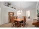 Elegant dining room with a wooden table, china cabinet, and neutral decor at 6626 S Reed Way # A, Littleton, CO 80123