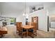 Spacious dining area featuring wood furniture, neutral carpet, and ample natural light at 6626 S Reed Way # A, Littleton, CO 80123