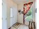 Inviting entryway with tile flooring, a white front door, and a side table at 6626 S Reed Way # A, Littleton, CO 80123