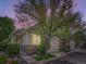 Charming home featuring stone accents, attached garage, and professionally landscaped front yard at 6626 S Reed Way # A, Littleton, CO 80123