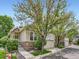 Attractive home with stone accents, a two-car garage, and mature landscaping at 6626 S Reed Way # A, Littleton, CO 80123