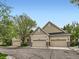 Beautiful home exterior showcasing the roof, siding, multiple garages, and manicured landscaping at 6626 S Reed Way # A, Littleton, CO 80123