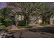 The front of the property with an attached garage, stone and siding exterior, and landscaping at 6626 S Reed Way # A, Littleton, CO 80123