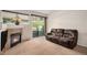 Inviting living room featuring a fireplace, sliding glass door, and comfortable, dark sofa at 6626 S Reed Way # A, Littleton, CO 80123