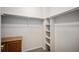 Walk-in closet featuring carpet, shelves, hanging bars, and wood drawers at 6626 S Reed Way # A, Littleton, CO 80123