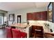 A home bar area featuring stone accents, granite countertops, wooden cabinets, and bar stool seating at 73 Falcon Hills Dr, Highlands Ranch, CO 80126