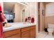 Well-lit bathroom featuring a spacious vanity with tile countertop, ample lighting, and neutral color palette at 73 Falcon Hills Dr, Highlands Ranch, CO 80126