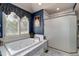 Relaxing bathroom featuring a jacuzzi tub, tiled walls, and a glass-enclosed shower at 73 Falcon Hills Dr, Highlands Ranch, CO 80126