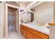 Bathroom featuring double sinks, a large mirror, and a separate shower area, providing a spa-like experience at 73 Falcon Hills Dr, Highlands Ranch, CO 80126