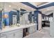 Luxurious bathroom with dual sinks, a vanity area, and plenty of mirrored cabinet space at 73 Falcon Hills Dr, Highlands Ranch, CO 80126