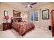 Inviting bedroom with a large window, ceiling fan, plush bedding, and matching nightstands at 73 Falcon Hills Dr, Highlands Ranch, CO 80126