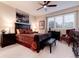 Relaxing bedroom with dark wood furniture, a patterned bedspread, large window with shutters and ceiling fan at 73 Falcon Hills Dr, Highlands Ranch, CO 80126