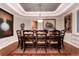 Formal dining room with elegant lighting, tray ceiling, and seating for eight at 73 Falcon Hills Dr, Highlands Ranch, CO 80126