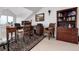 Charming home office with wooden desk, comfortable chairs, classic bookcase, and area rug at 73 Falcon Hills Dr, Highlands Ranch, CO 80126